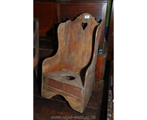 An antique Mahogany high back child's/miniature rocking/Lambing style Chair having commode recess/aperture, and having fretwo