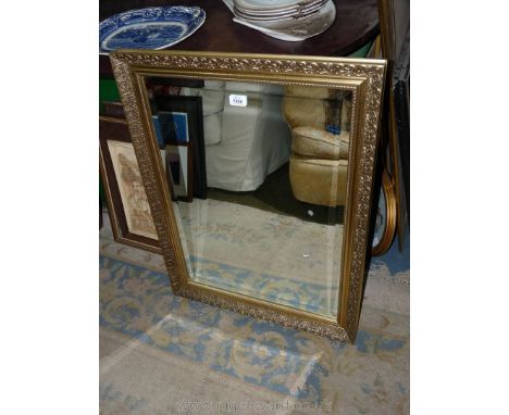 A bevel plated wall Mirror in ornate gilt colour.
