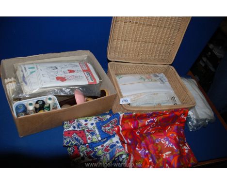 A wicker Hamper of vintage tablecloths and sewing items including  tray cloths, darning mushrooms, wooden cotton reels, patte