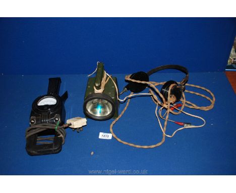 A bakelite clamp amp meter, military torch and pair of vintage headphones