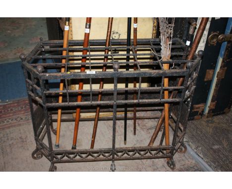 A heavy wrought iron stick Stand, six side irregular shape, 34'' long, 14'' wide x 27'' high overall