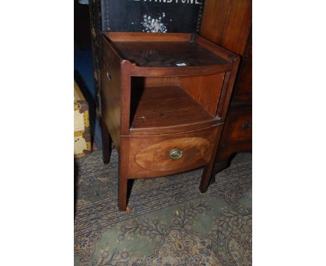 A Georgian Mahogany bow fronted tray-top Commode having fretworked side handle recesses, a slide-out commode base with oval v