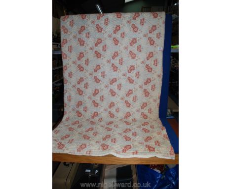 A Welsh quilt, light blue background with red flowers.