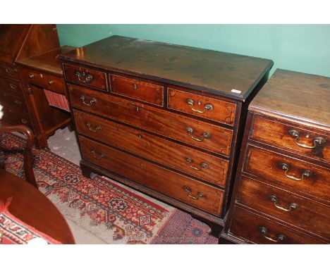 A Georgian Mahogany Chest of three long and three short Drawers having brass swan neck drop handles, the drawer fronts unusua