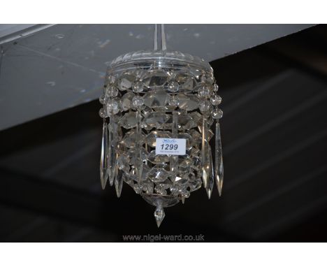 A pretty glass/crystal chandelier having domed cut glass top supporting 10 strings of compressed diamond shaped prisms conver
