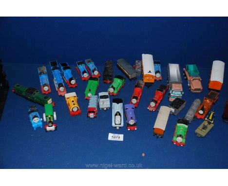 A quantity of small Thomas the Tank Engine trains and carriages.