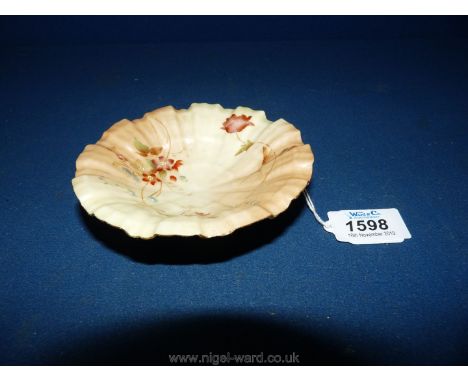 A Royal Worcester porcelain blush ivory circular fluted Dish, hand-painted with flowers and gilt standing on three moulded sh
