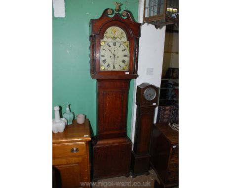 An Oak cased eight day longcase Clock having light and darkwood stringing, the painted face with floral details to the corner