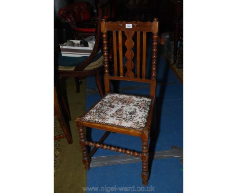 An arts and crafts Mahogany framed side Chair having turned details and fretworked central backrest details and floral uphols