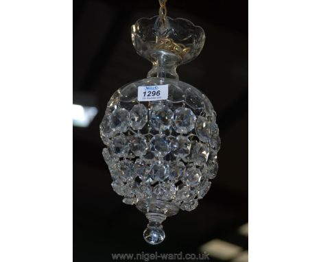 An elegant glass chandelier having a cut and polished glass dome with thumb cut details and with an electrical fitting incorp