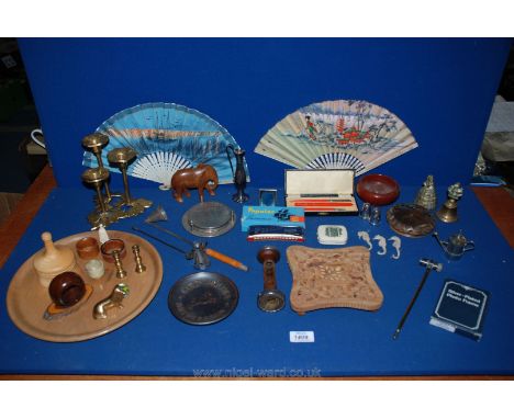 A quantity of miscellanea including treen elephant and napkin rings, brass bell and dog, harmonica, coasters, etc.