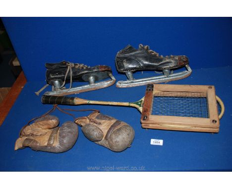 A pair of vintage ice hockey Boots, vintage boxing gloves and badminton racket.