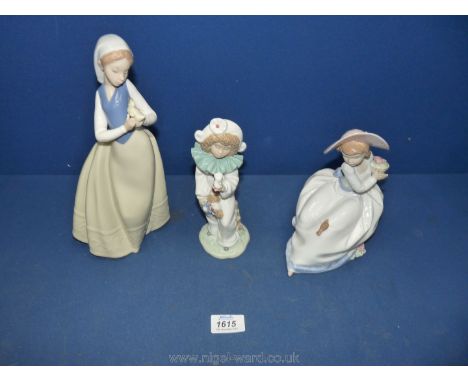 Three Nao figures, a girl with bird on her hand, a clown and a girl sitting watching a bird.