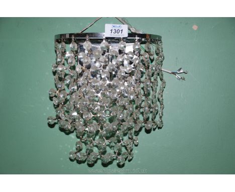 A contemporary wall light/chandelier having chromium plated finish fittings and small bulb illumination, approx. 8" wide x 9 