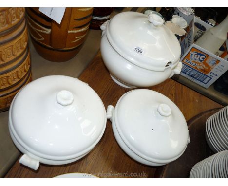 A large white Soup tureen and lid (ladle missing) and two white lidded vegetable dishes.