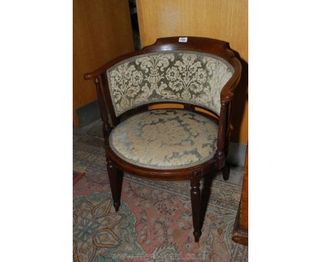 An elegant 19th c. circular seated Mahogany framed curved backed Elbow Chair standing on turned and well reeded legs and with