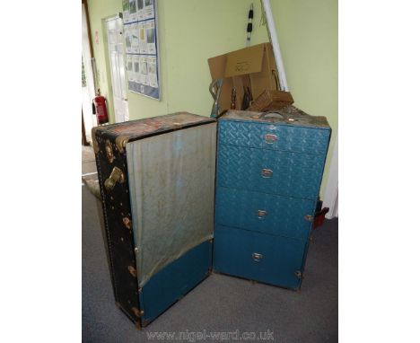A well travelled ''Oshkosh Trunks Inc'' Trunk/portable wardrobe having metal bound corners, various labels including British 