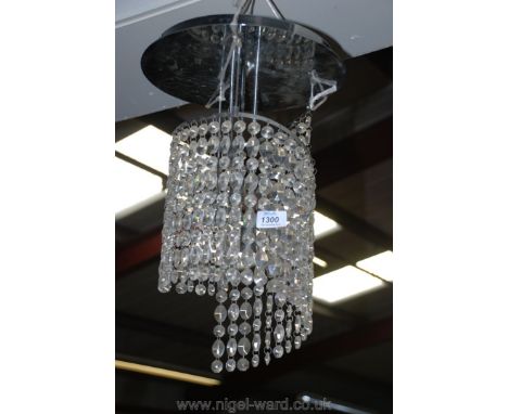 A contemporary chandelier with stainless steel/chromium plated finish and having descending spirally arranged string droppers