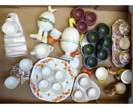 A collection of egg cruets and novelty egg cups including Old Foley, Chintz, Bakelite, Carltonware, Goebel etc, tallest 13cm