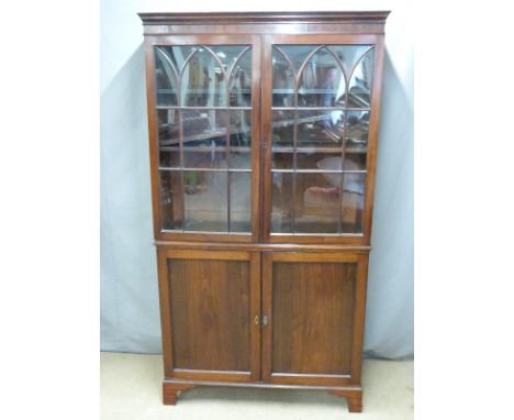 A 19thC glazed cabinet with adjustable shelves and cupboards under raised on bracket feet, W100 x D33 x H184cm