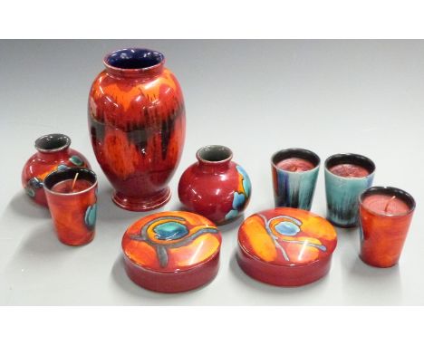 A collection of Poole pottery including a pedestal vase, pair of vases, covered pots and four candles, tallest 23cm&nbsp;&nbs