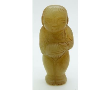 A 19thC Chinese jade toggle depicting a boy holding an object, H5.5cm
