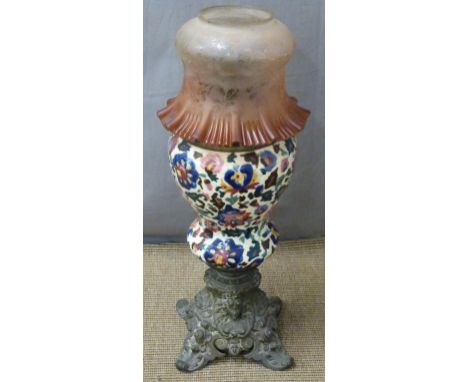 An earthenware oil lamp with frilled glass shade, H 62cm