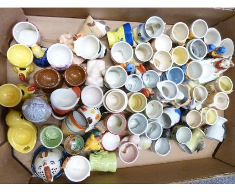 Approximately 50 novelty egg cups including retro, kitsch, Wade, Goebel, Danish pottery, Japanese examples etc