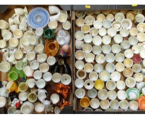 Approximately 130&nbsp;novelty egg cups including kitsch, retro, some named, pottery nursery ware etc
