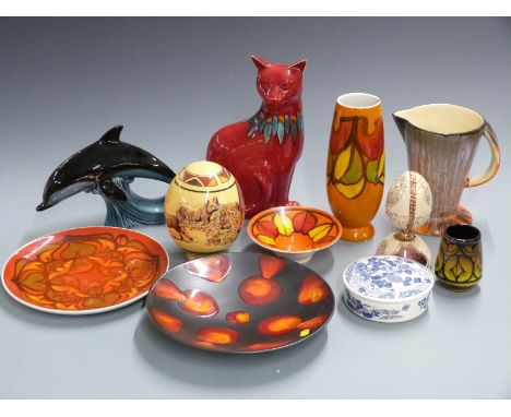 A collection of ceramics including Poole pottery cat and dolphin, decorated egg etc, tallest 30cm