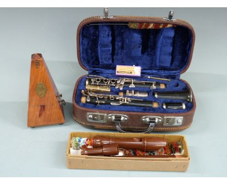 A cased Lark clarinet, together with a Dolmetsch treble recorder and a French-made metronome