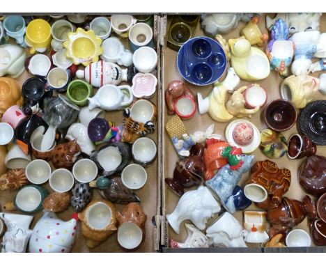 Two trays of&nbsp;novelty egg cups including Spitting Image, pottery etc