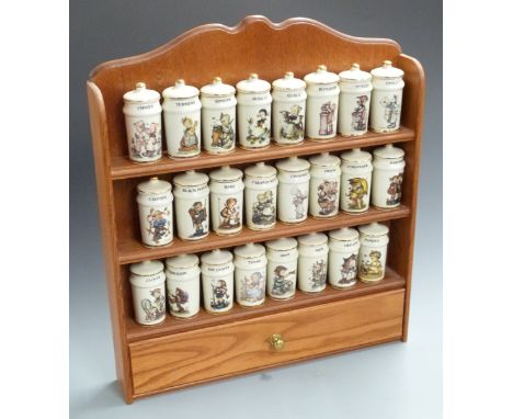 A set of 24 Hummel spice jars on wooden wall mounted shelf unit with drawer below&nbsp;