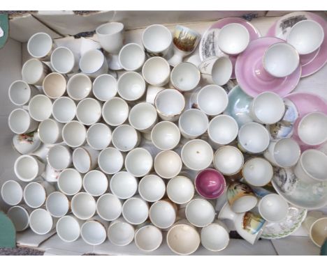 Approximately 70 novelty egg cups including nursery ware, Beatrix Potter, souvenir ware etc