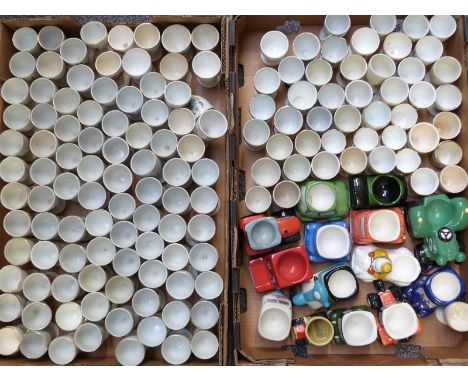 Approximately 140 novelty egg cups, mainly crested, and a small quantity of transport related