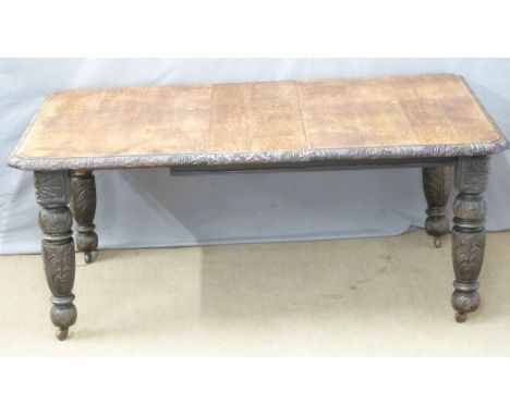 19thC oak wind-out extending dining table with carved edge and legs and two extra leaves, labels to frame for Phillips &amp; 