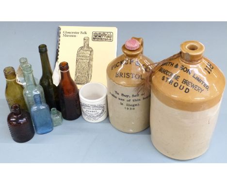 Two stoneware flagons for Smith and Son, Brimscombe, Stroud (height 32cm) and Pickup &amp; Co Bristol, and glass bottles incl