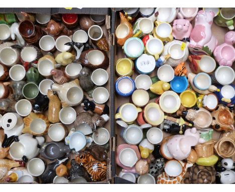 Two trays of novelty ceramic egg cups, mostly animal / bird related, some by Quail