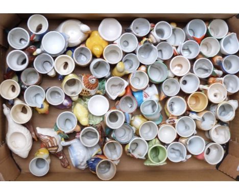 Approximately 60 novelty egg cups including figural, retro, kitsch, Japanese etc