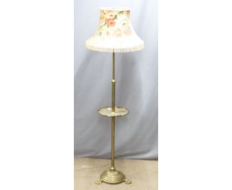 A brass adjustable standard lamp with shelf&nbsp;raised on pad feet, H170cm