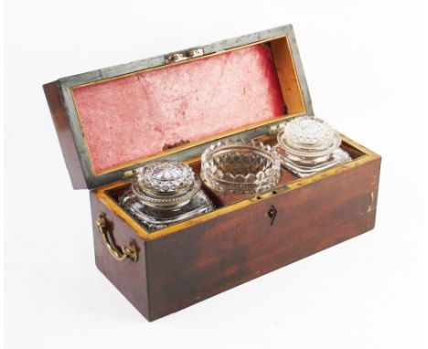 An early 19th century mahogany tea caddy, the rectangular hinged cover enclosing a pair of facet cut glass jars and stoppers 