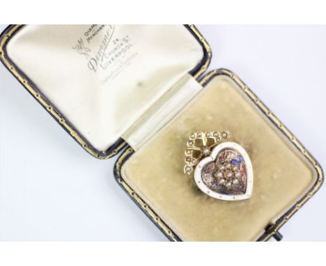 A Victorian heart shaped memorial brooch, designed as a central seed pearl floral cluster, within a blue enamel surround (at 