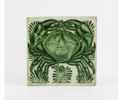 A William De Morgan glazed ceramic tile, decorated with a green glaze depicting a crab, embraced by stylised foliage, 15cm sq