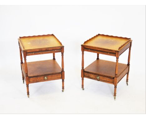 A pair of Regency style yew wood lamp or side tables, 20th century, each table with a galleried top above a sliding tray and 