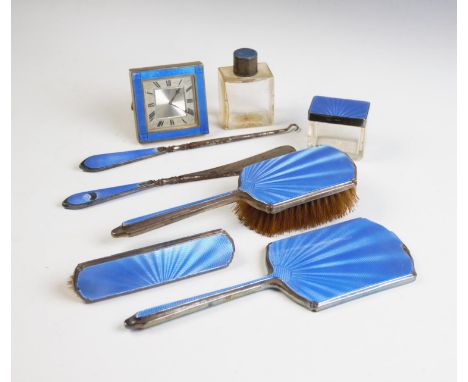 An Art Deco harlequin dressing table set, each piece with silver mount and blue guilloche enamel, comprising; a bedside timep