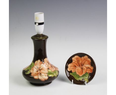 A Moorcroft table lamp in the Hibiscus pattern on a brown ground, 26.5cm high including fitting, together with a matching Hib