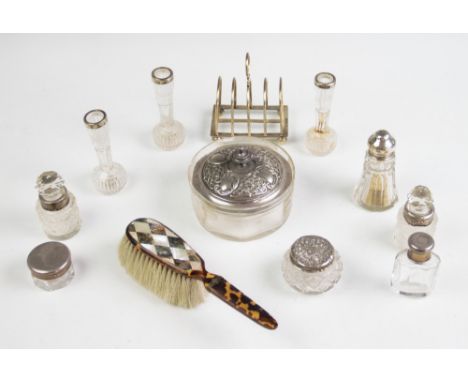 A George V silver four slice toast rack, Barker Brothers, Chester 1917, 10cm high, 3.25ozt, with a selection of dressing tabl