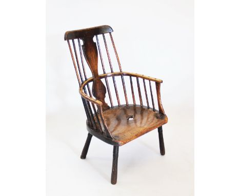 An 18th century walnut and ash west country windsor chair, the comb back windsor chair with spindle and vase shaped splat bac