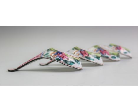 A set of four 18th century Chinese export enamel rice spoons, with ruyi shaped terminals and decorated with figures to the ex