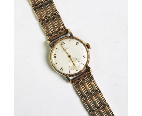 A gentlemen's Longines 9ct gold wristwatch, the circular face with Arabic and arrow head dial with subsidiary seconds dial, a